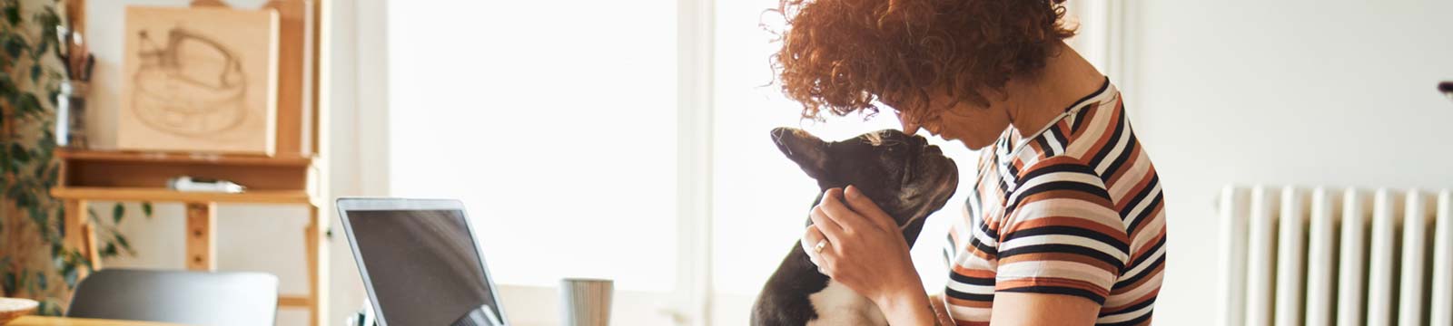 Person holding and loving their dog.