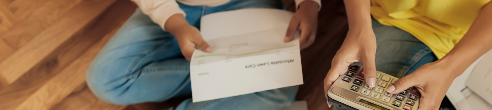 Woman holding calculator and child holding paper