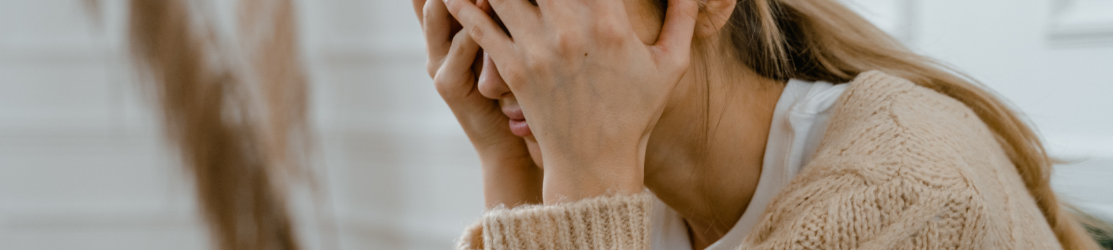 Woman with head in her hands upset