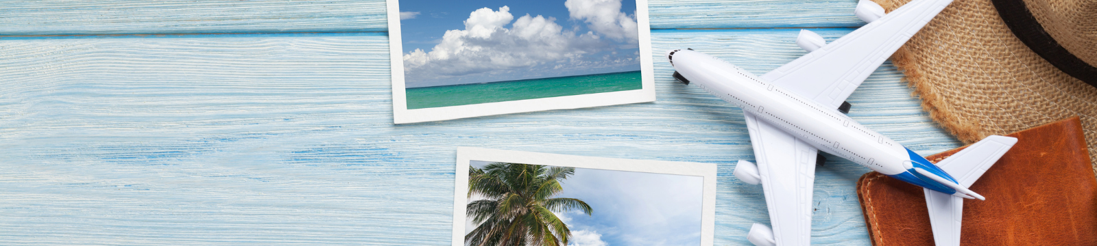 Collage of vacation polaroids, toy airplane, beach hat, and passport book.